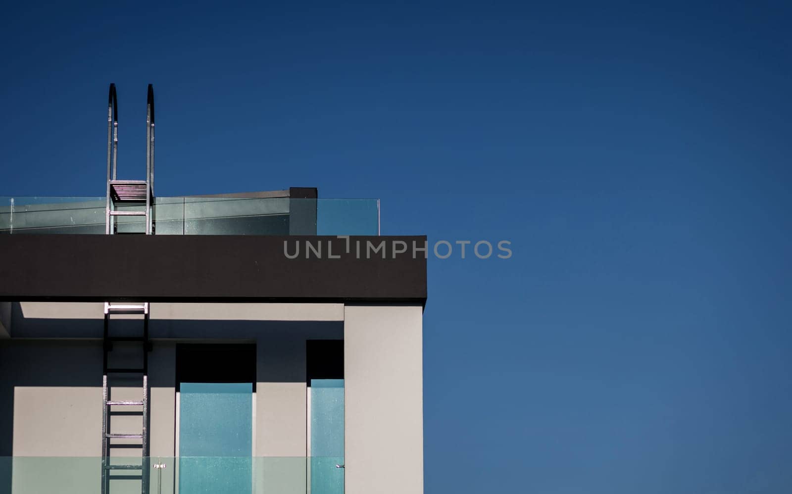 luxury villa with window and ladder over blue sky background