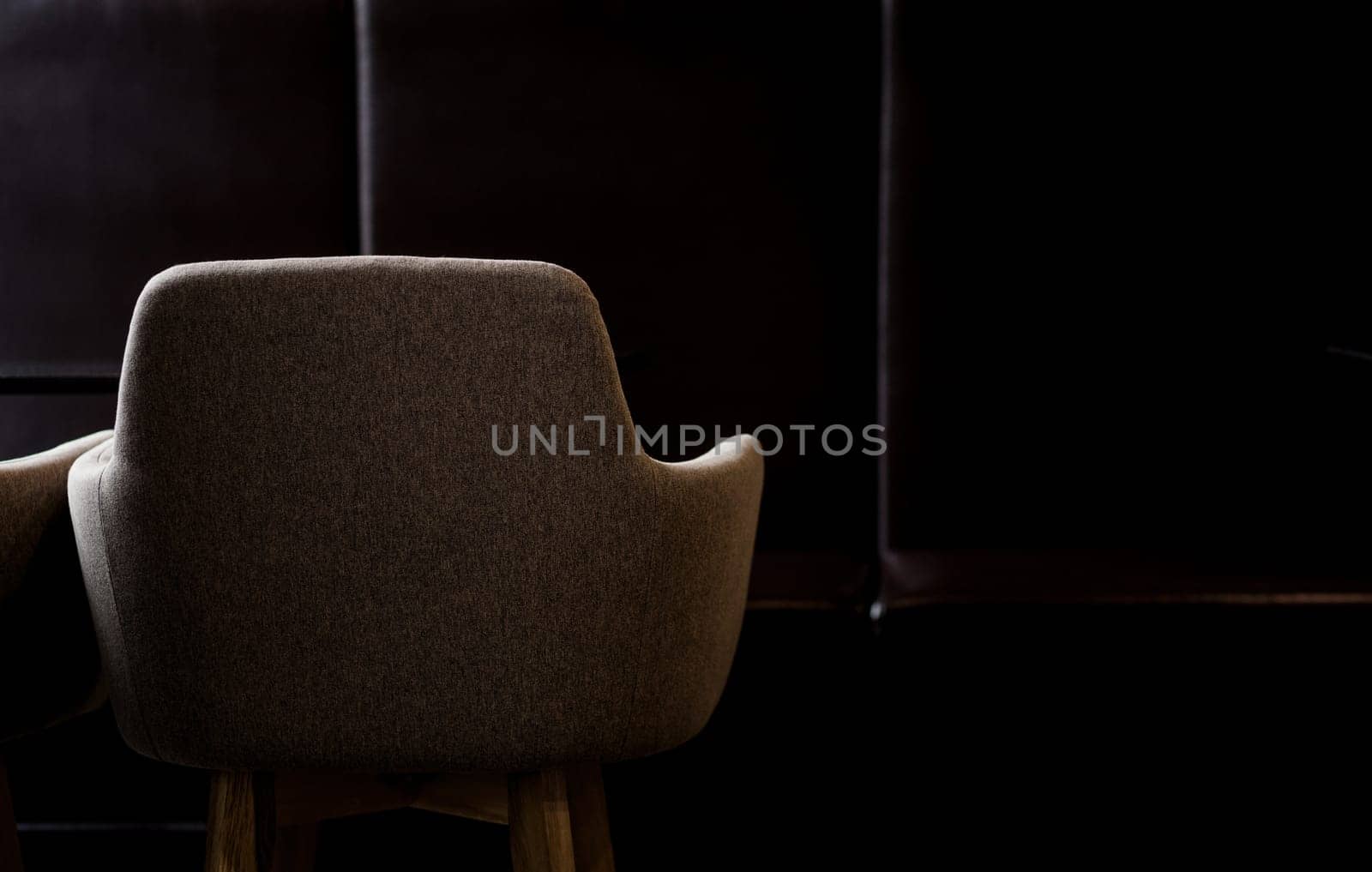 minimalistic dark interior of a cafe with an armchair