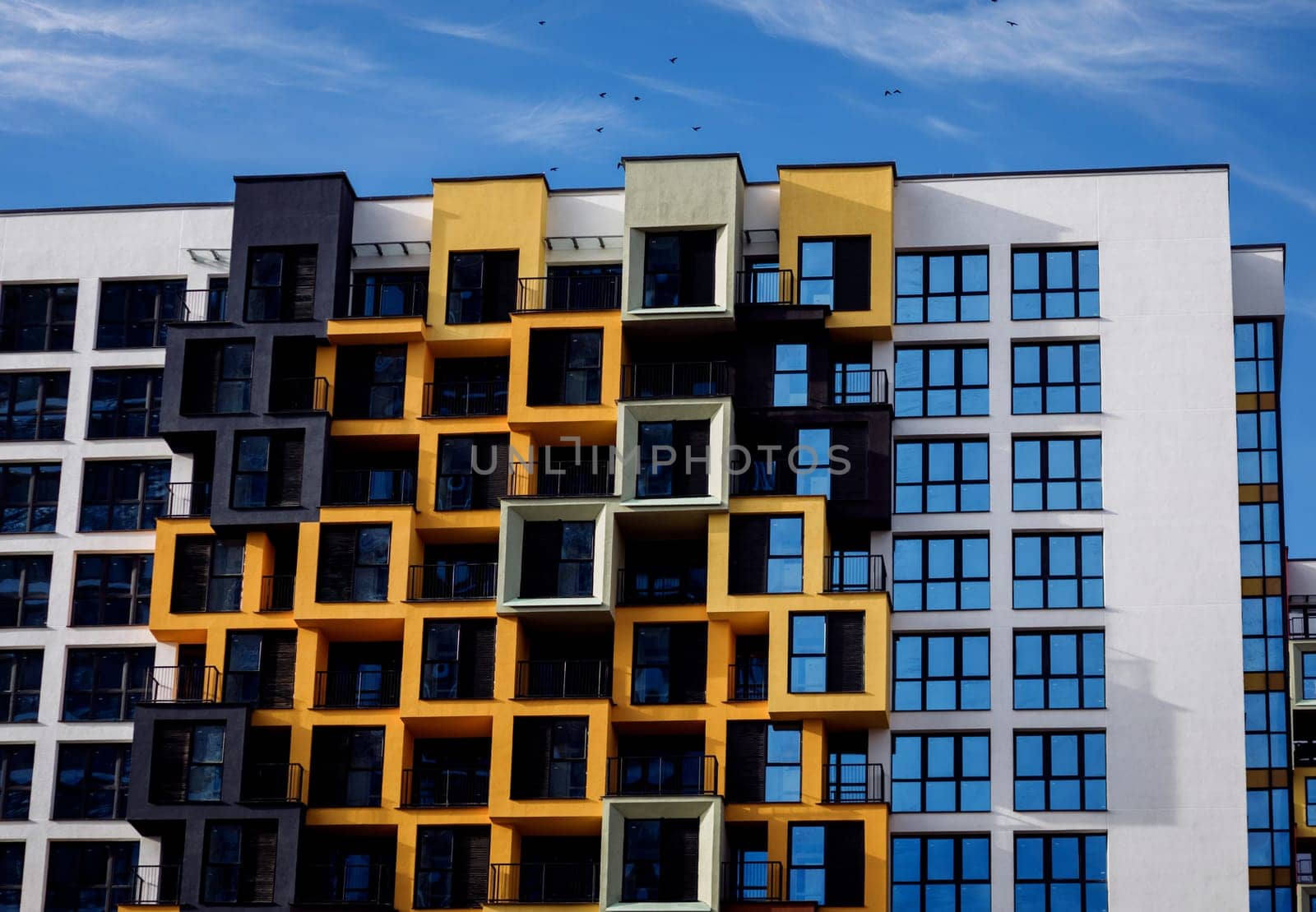 new modern apartment building with multicolored balconies
