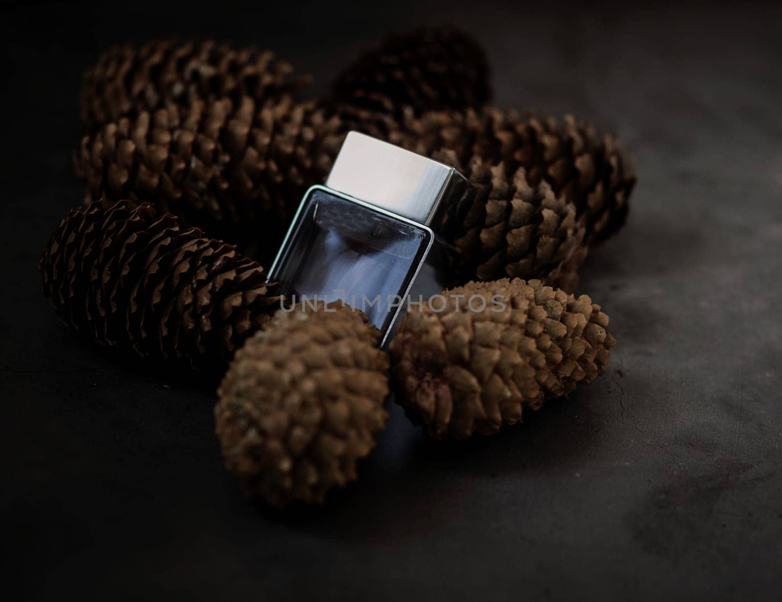 eco perfume. men's perfume on the background of cones. the concept of ecology