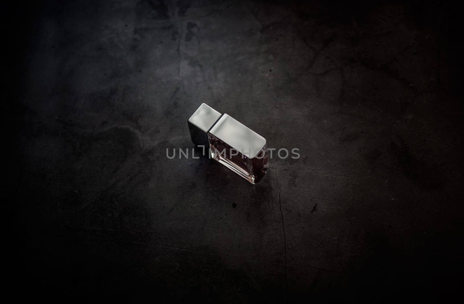 fragrance perfume bottle on dark empty background. Top view. Horizontal