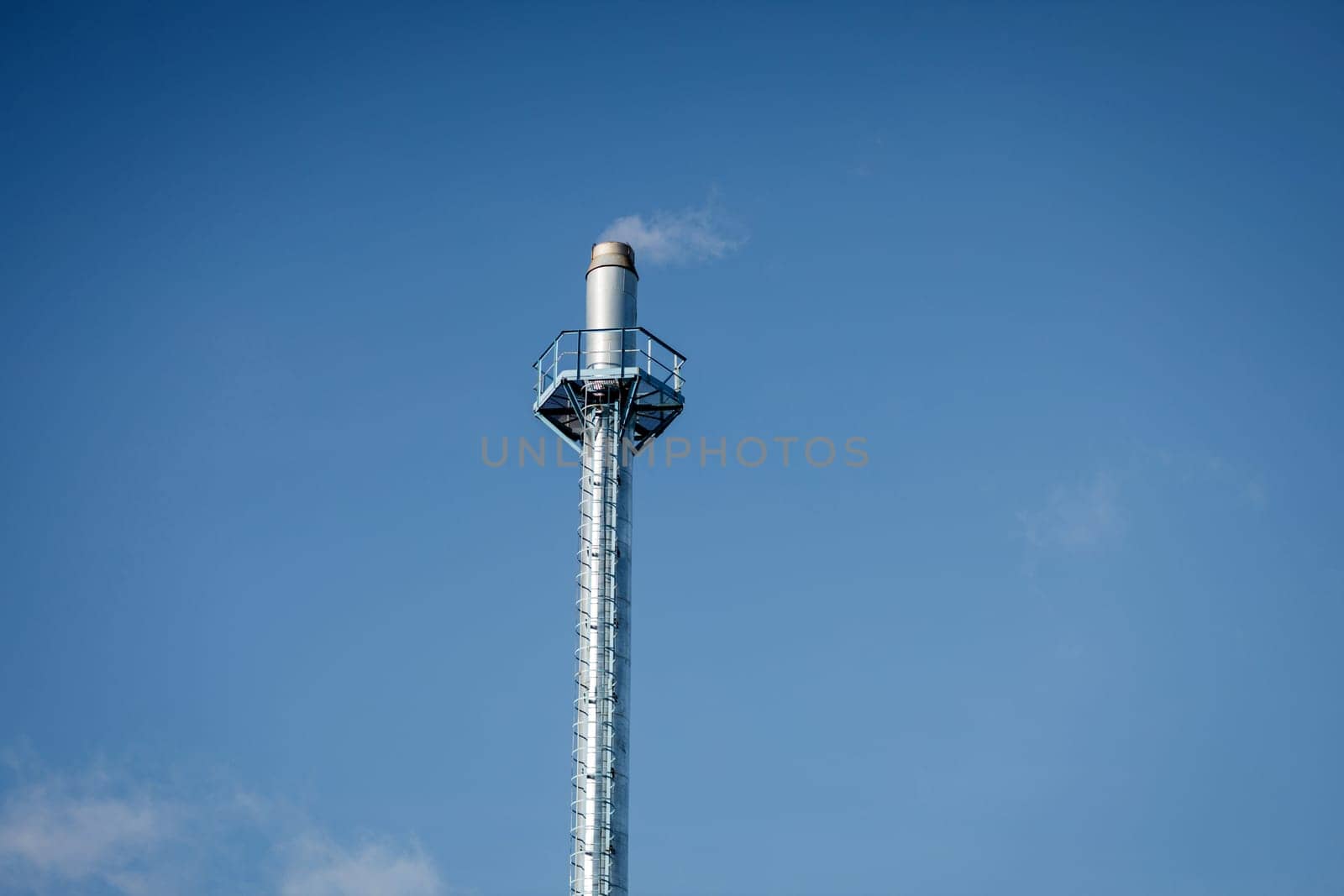 Smoke tower of industrial factory. Chimney smokestack emission