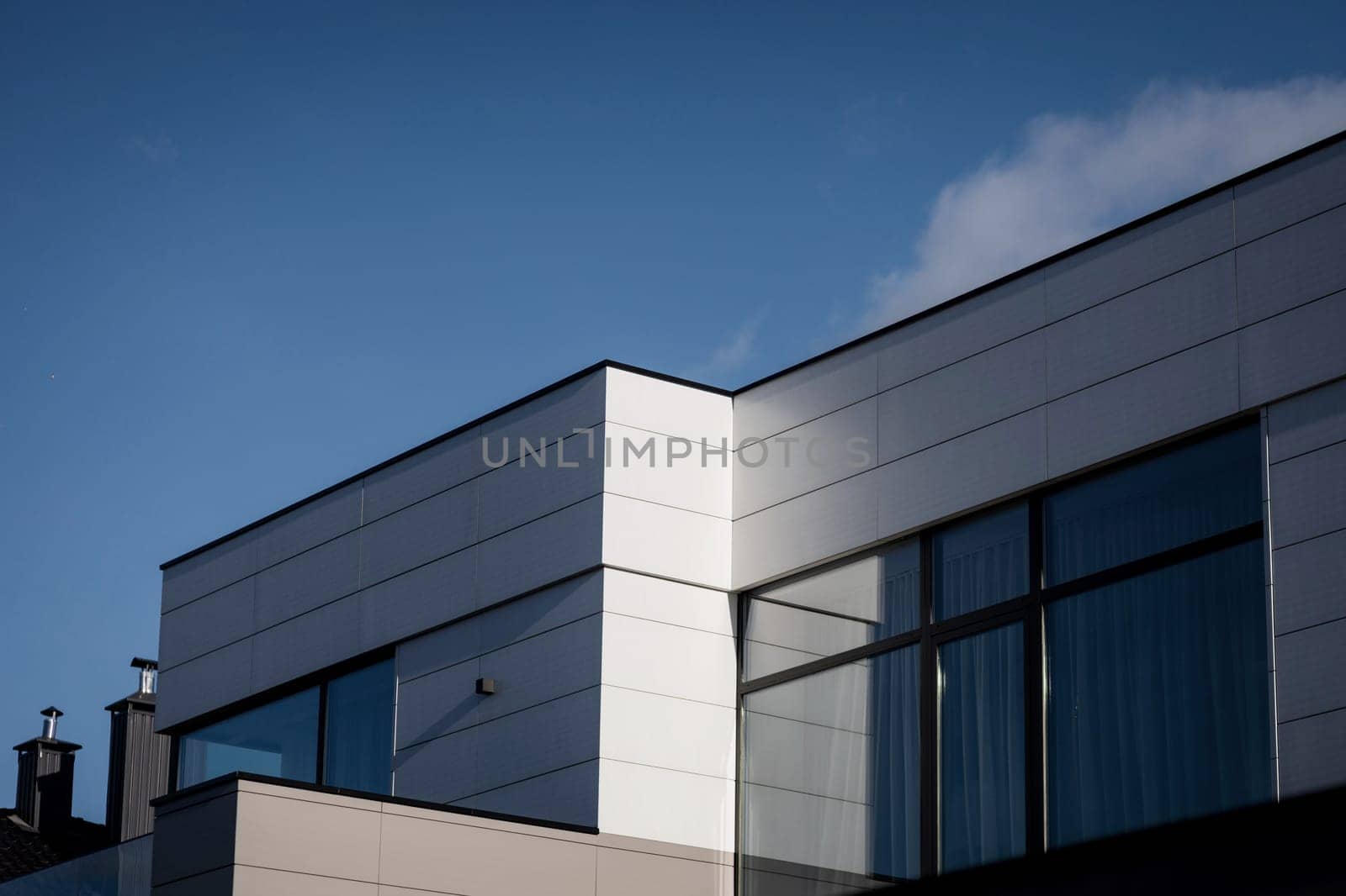 modern villas in Europe. High-end, luxury housing development on a sunny day with shadows.