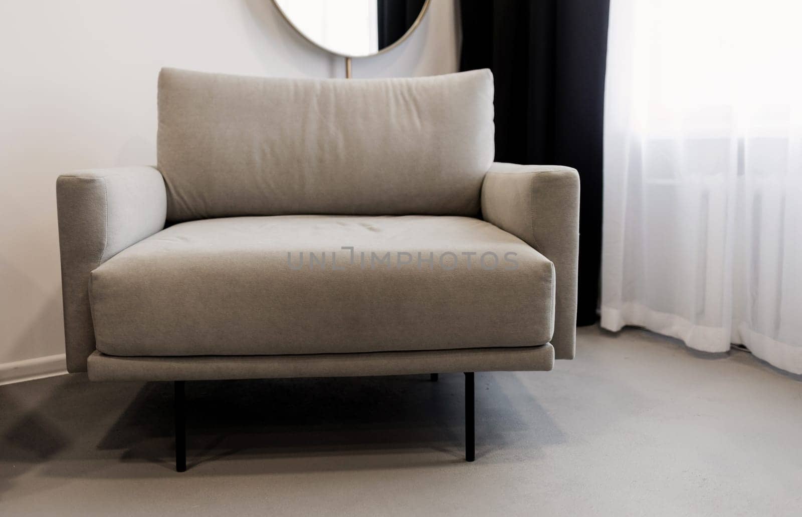 Cozy cabinet with chair in light room interior