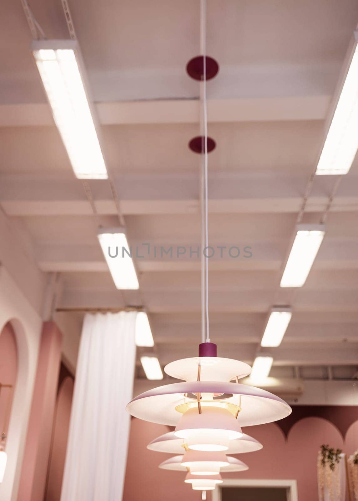 a row of glowing pendant lights in the apartment.