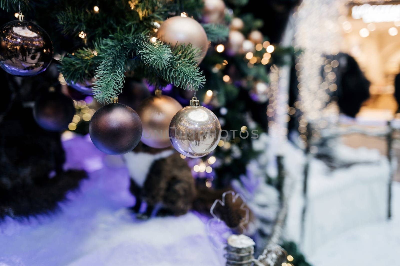 Closeup of bauble hanging from a decorated Christmas tree