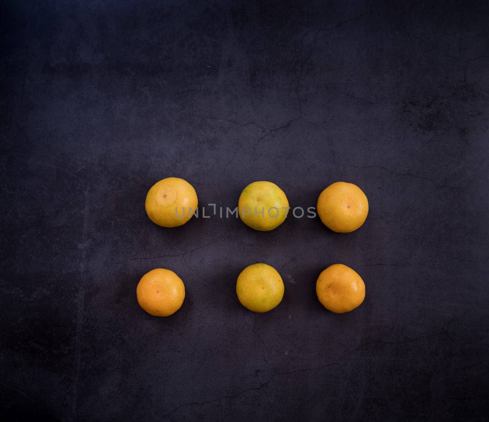 healthy eating. ripe yellow tangerines on a dark background. place for text. christmas mood