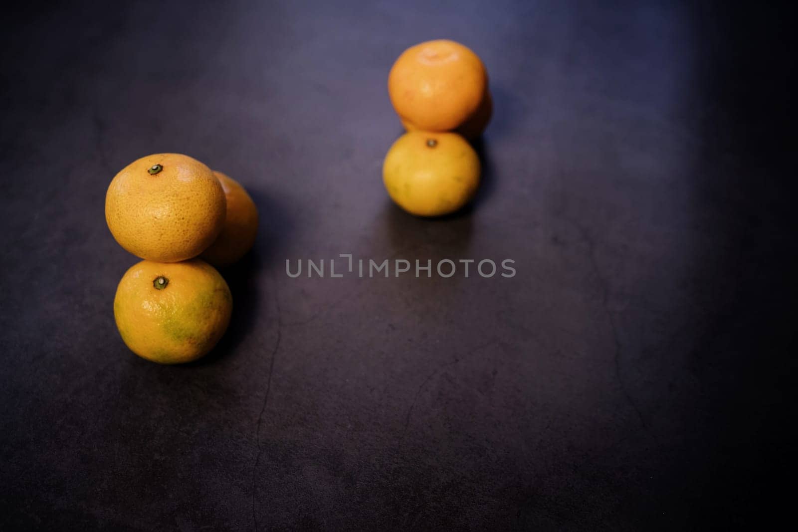 Six tangerines on dark table. clementines, citrus fruits. selective focus
