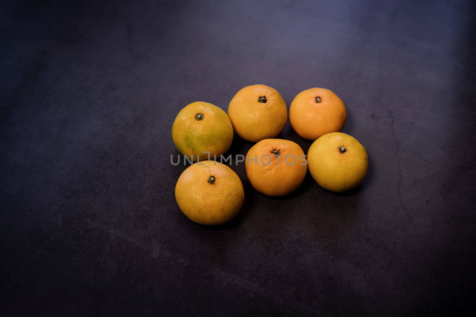 Fresh ripe tangerines and space for text on dark background, top view