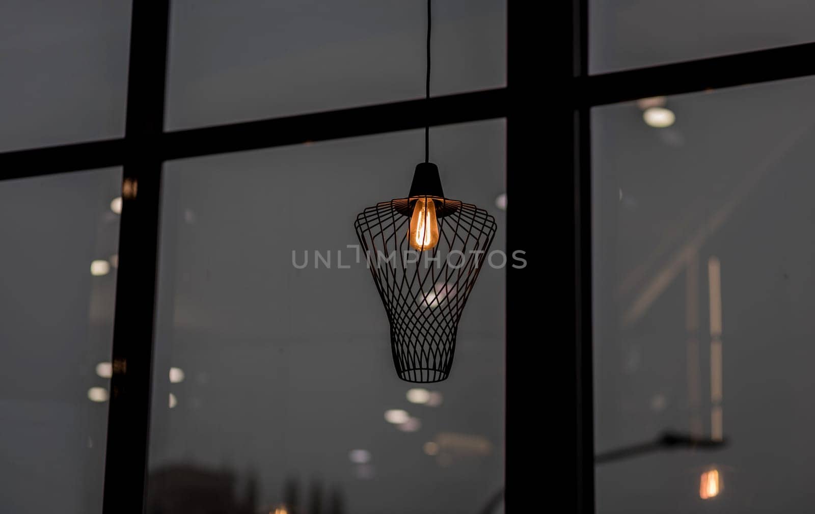 Modern metal decorative lamp on the background of the window