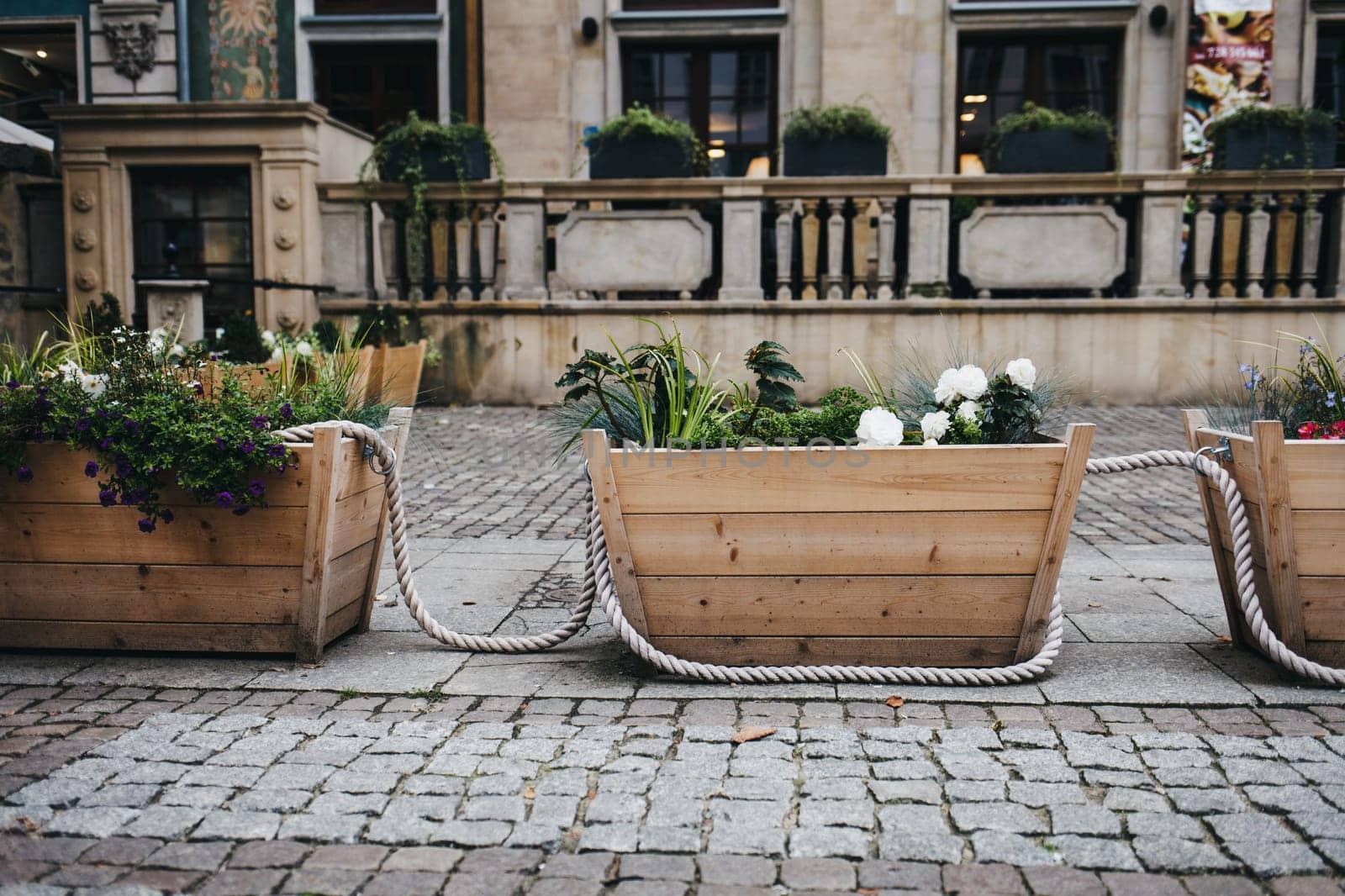 large wooden boxes with flowers and plants in a European city