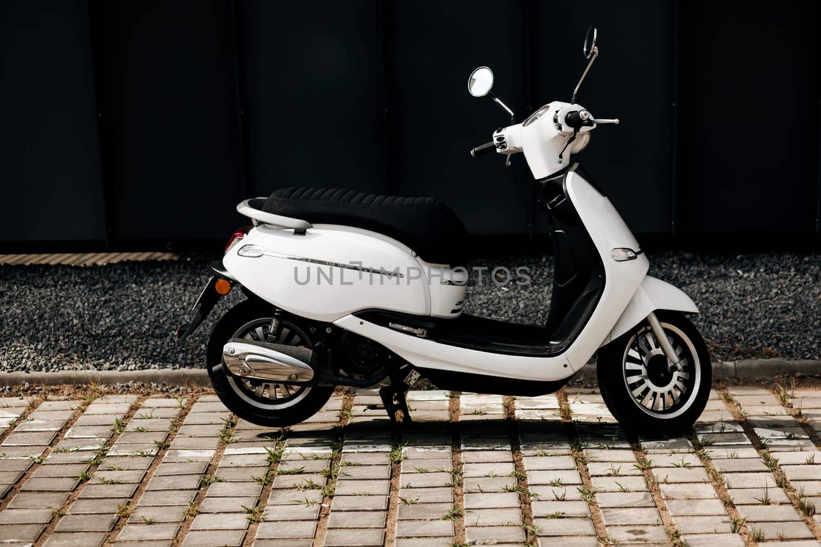 View of traditional white vintage moped on street in Europe