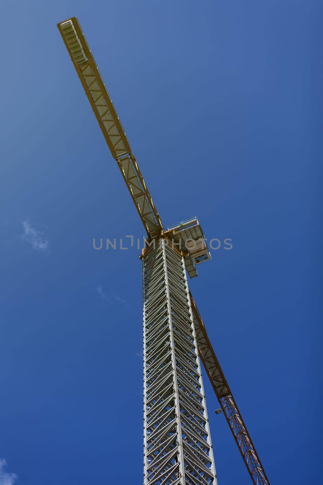 Industrial construction crane over blue sky on sunrise