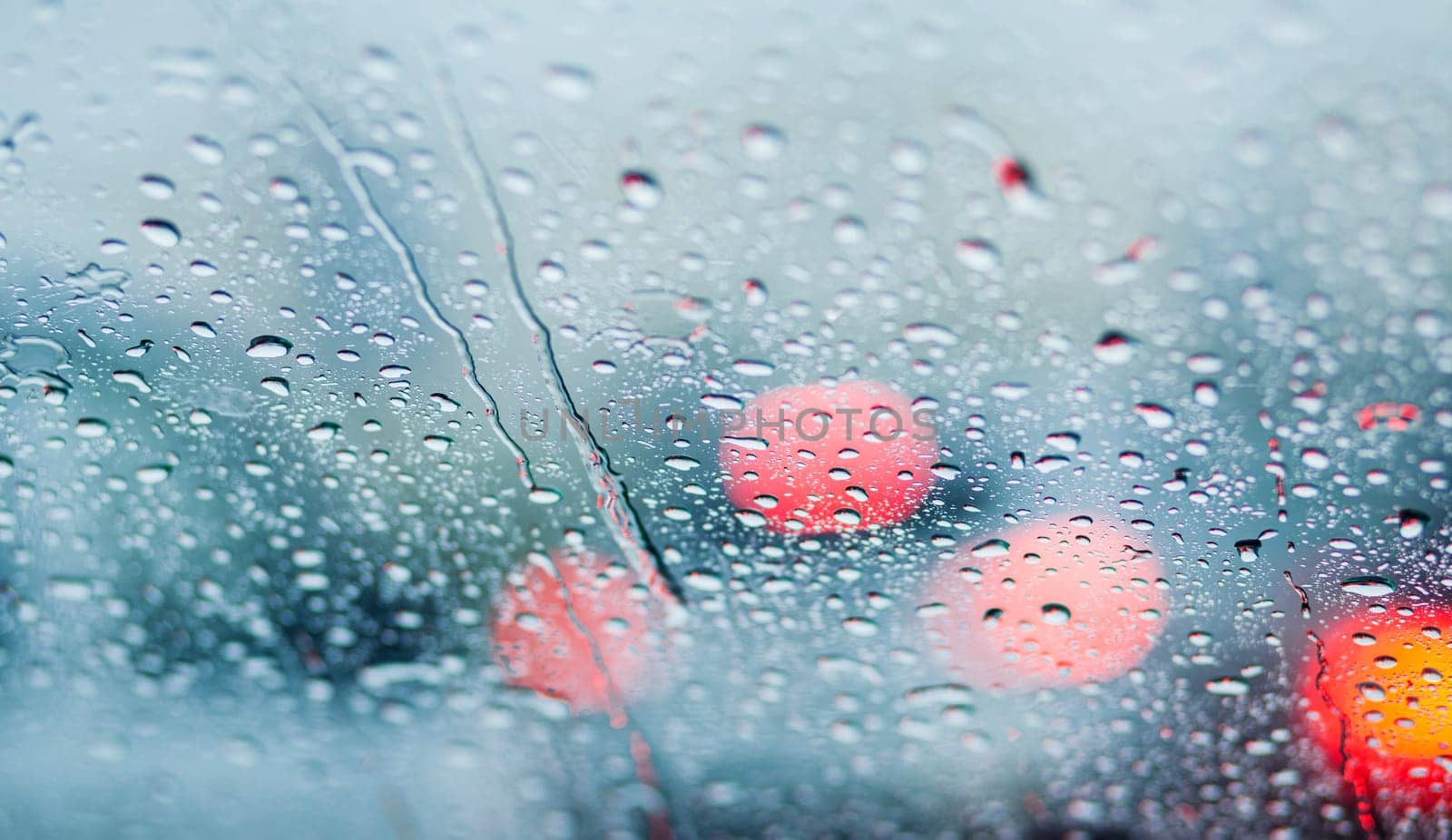 Raindrops on the transparent window pane. Background of raindrops.