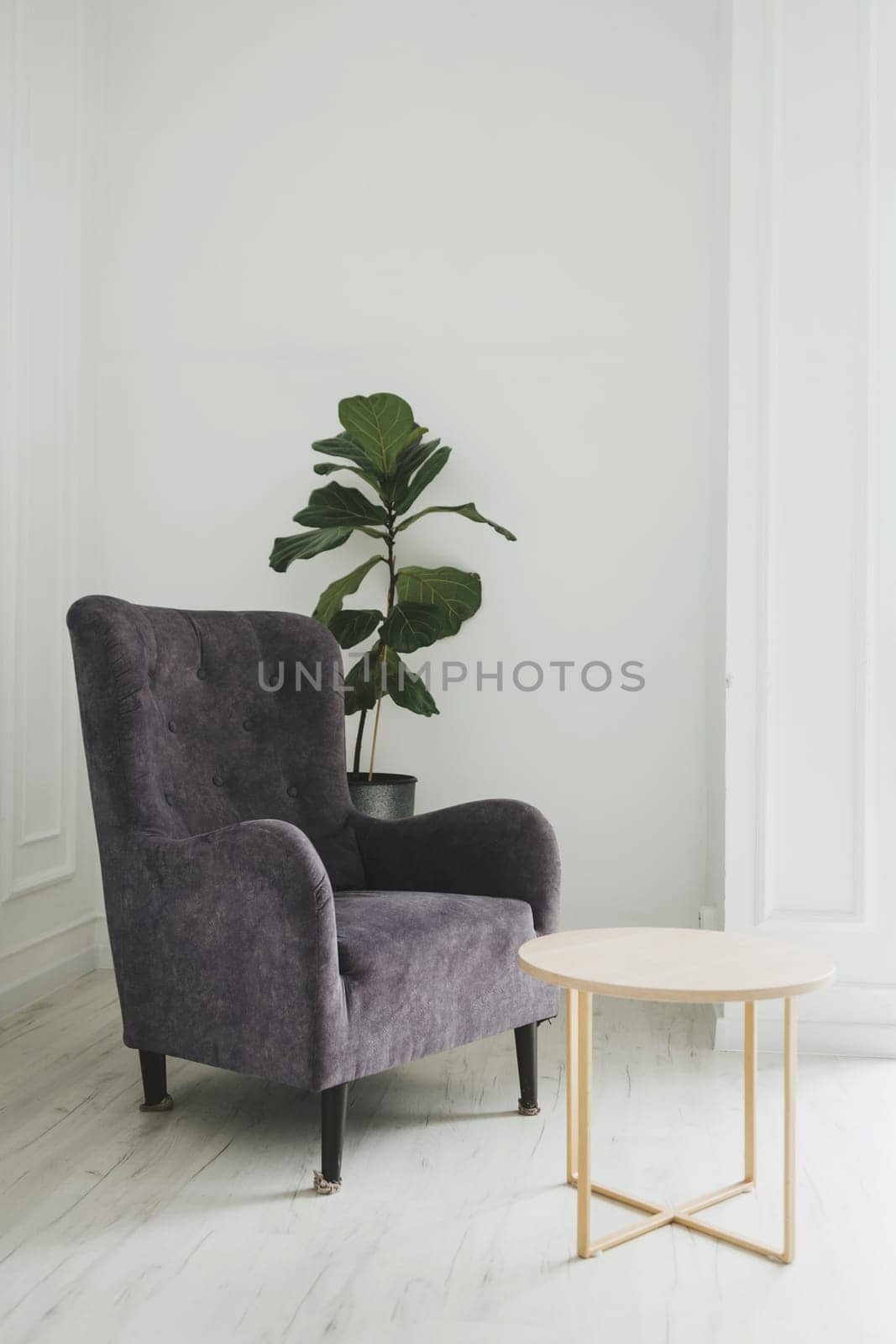 Modern armchair against white wall by Ladouski