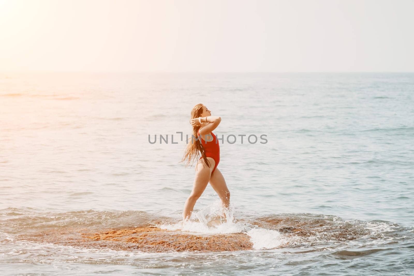 Woman sea yoga. Back view of free calm happy satisfied woman with long hair standing on top rock with yoga position against of sky by the sea. Healthy lifestyle outdoors in nature, fitness concept.