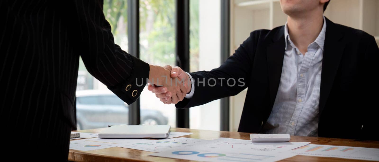 Meeting and greeting concept, Two business handshake and business people after discussing good deal of Trading contract and new projects, success, partnership.
