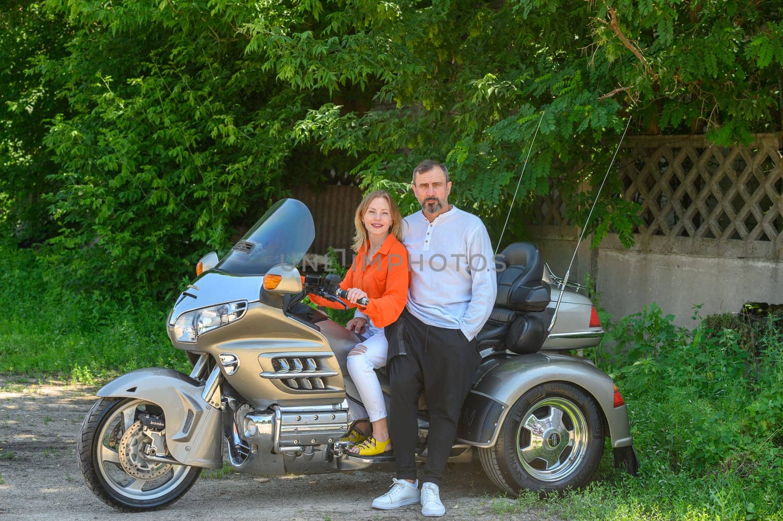 happy husband and wife sitting on a motorcycle 2