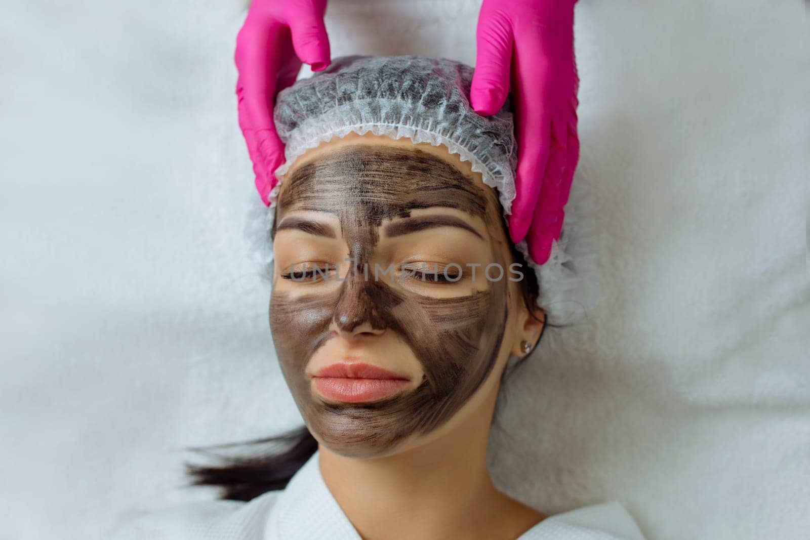 Close-up of carbon peeling procedure for middle-aged woman face. Laser pulses clean skin. Process of photothermolysis, warming, laser carbon peeling. Facial skin rejuvenation, cosmetology treatment