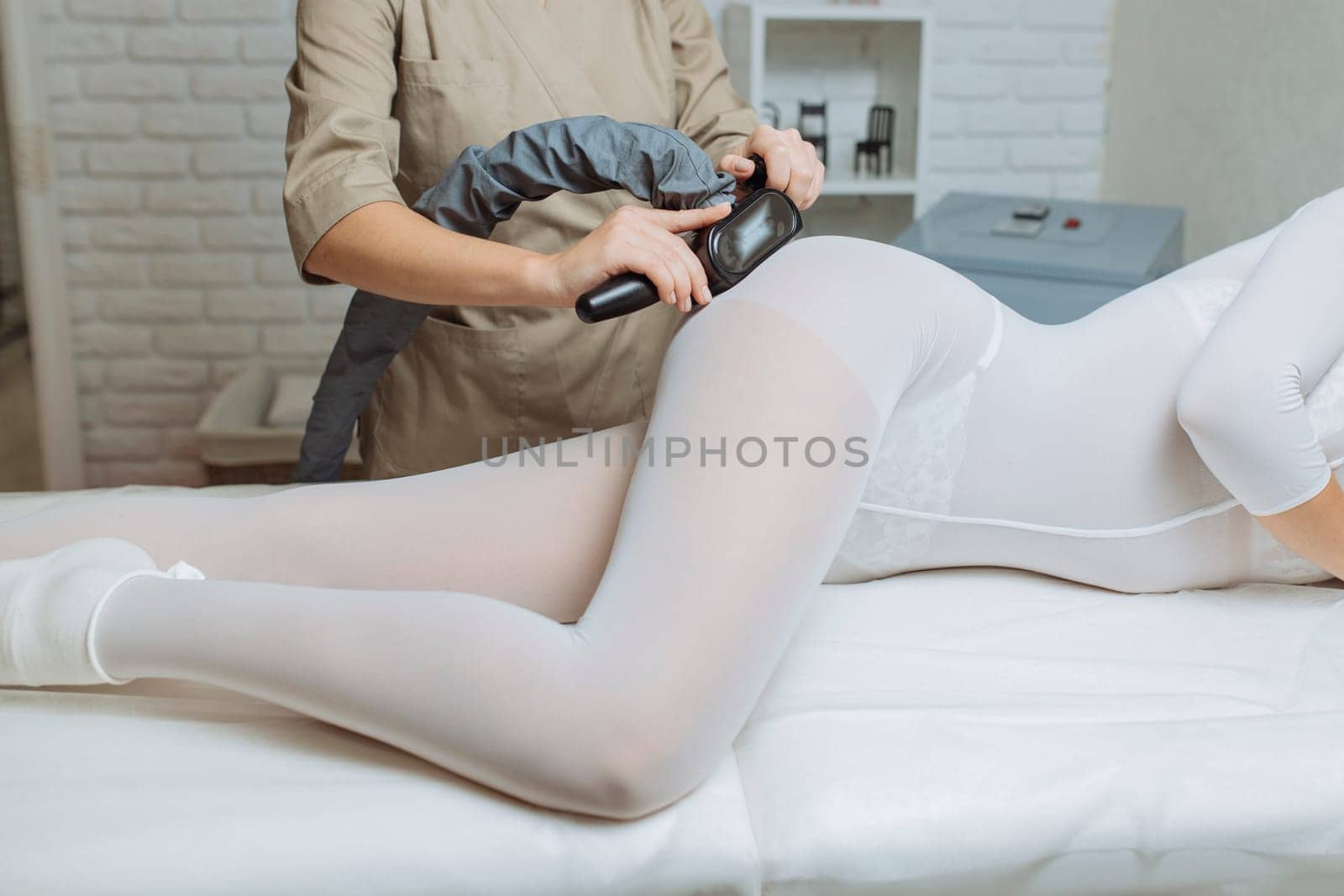 Beautiful woman getting beauty therapy against cellulite with LPG machine on her butt. LPG massage for lifting body