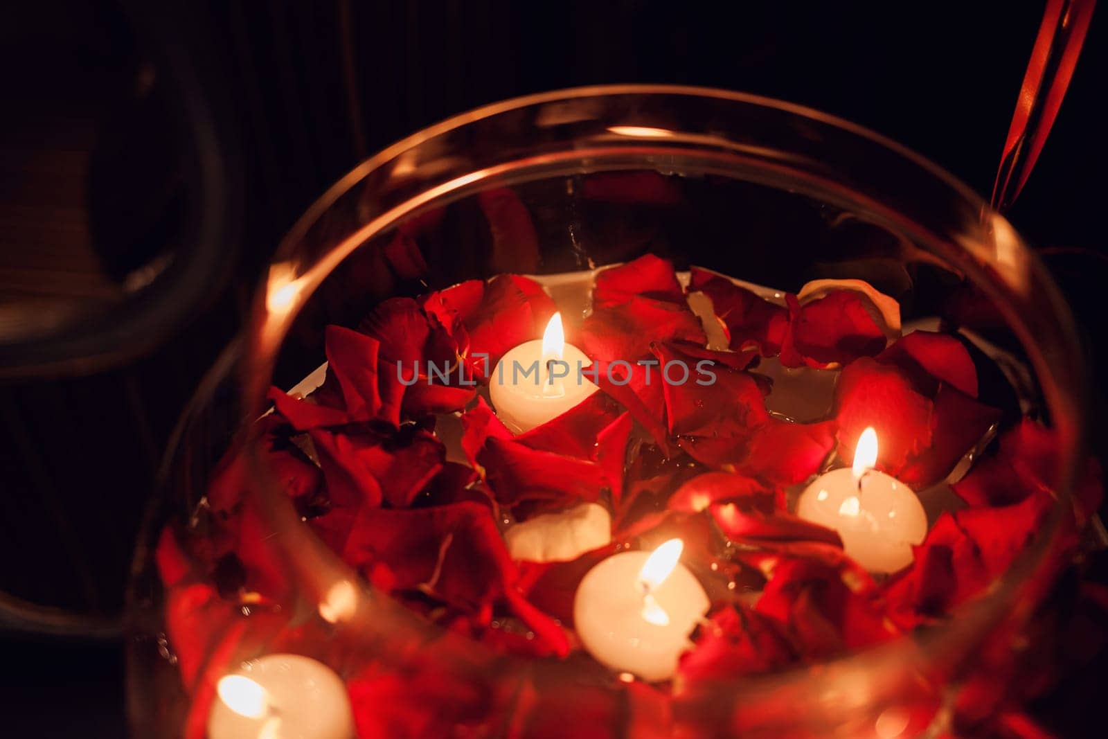 Rose petals in water with candles. Valentine's Day and March 8