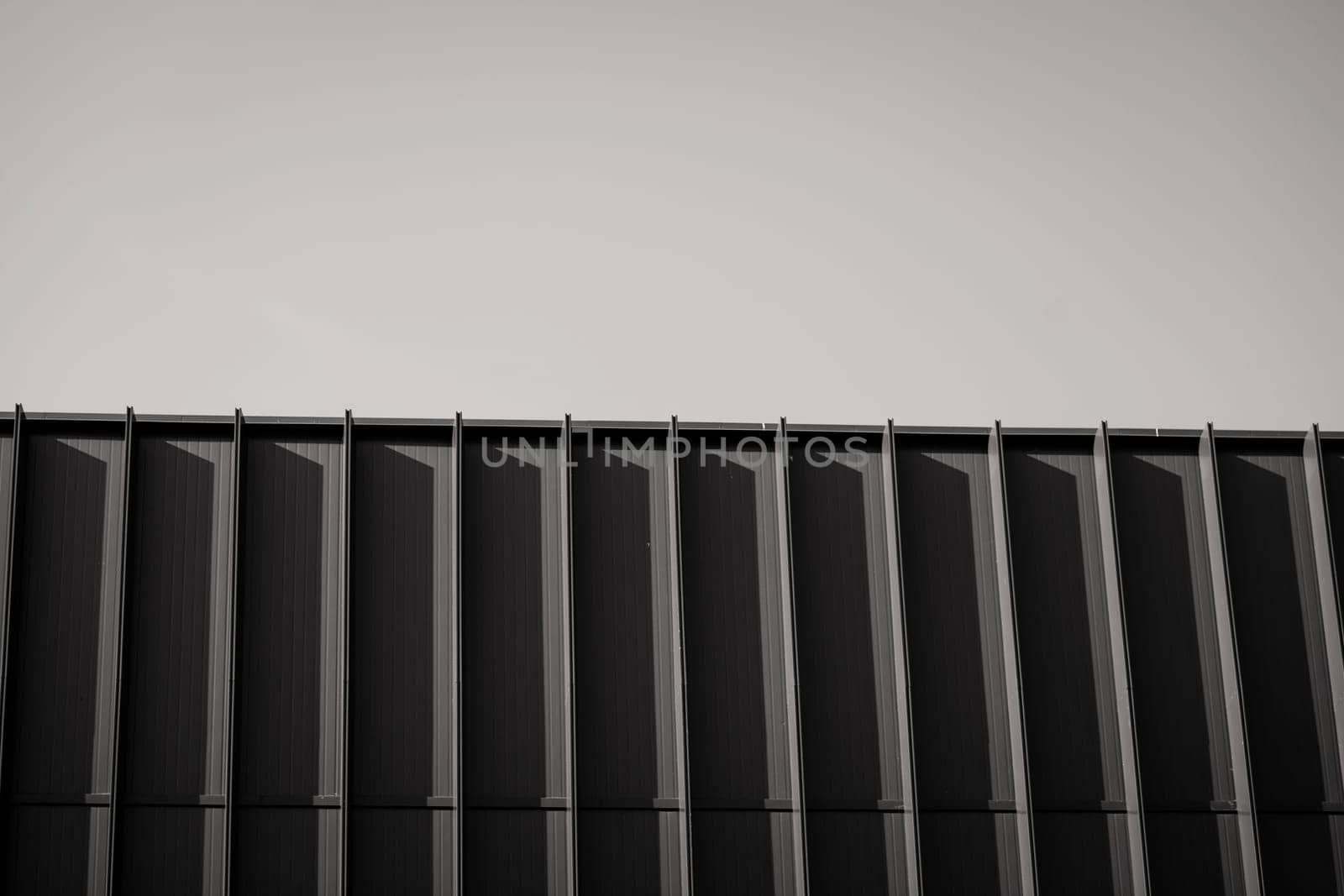 Business building. Abstract architecture, fragment of minimalistic urban geometry. Walls made of steel 