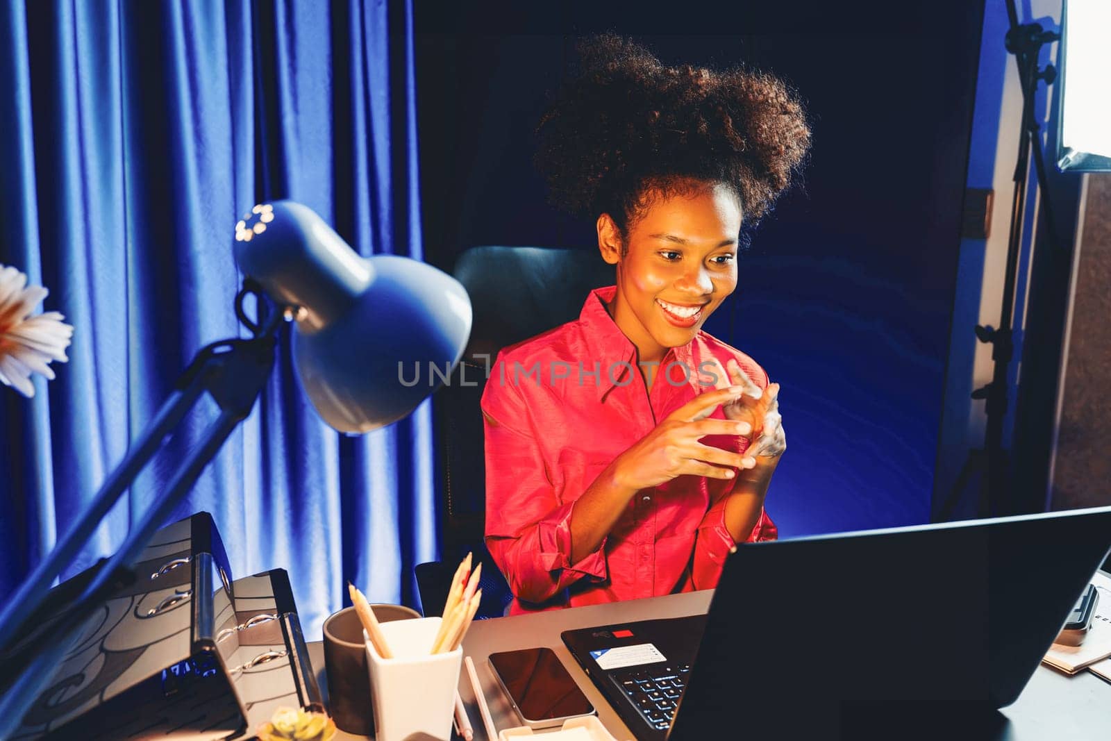 Working African woman with happy glowing, smiling face, getting new job project with good deal or marketing course scholarship information on laptop screen. Concept of cheerful expression. Tastemaker.