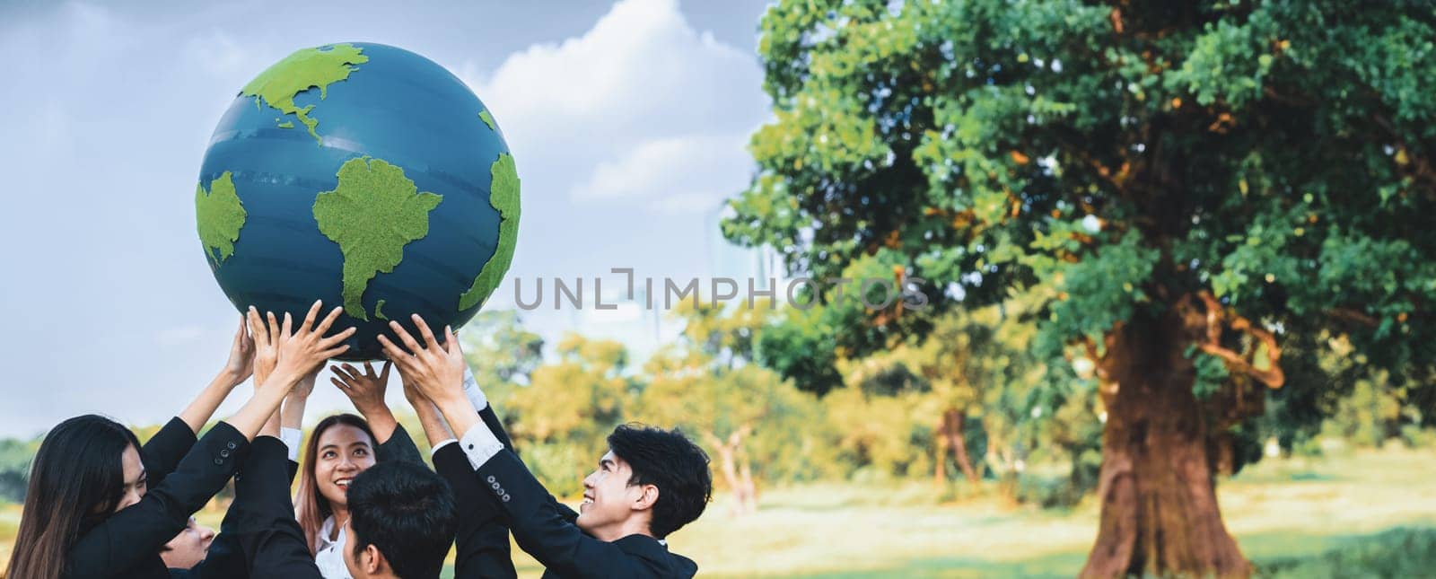 Earth day concept with big Earth globe held by group of asian business people team promoting environmental awareness with environmentally sustainability and ESG principle for brighter future. Gyre