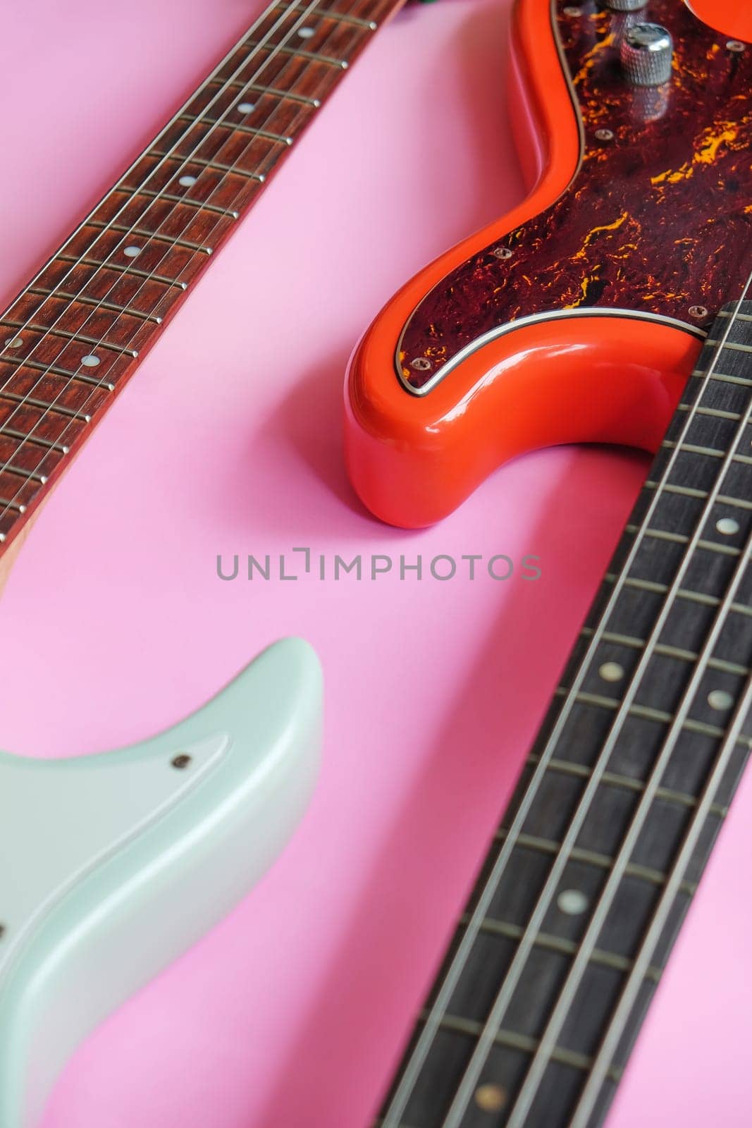 Electric guitar and bass guitar on a pink background by ponsulak