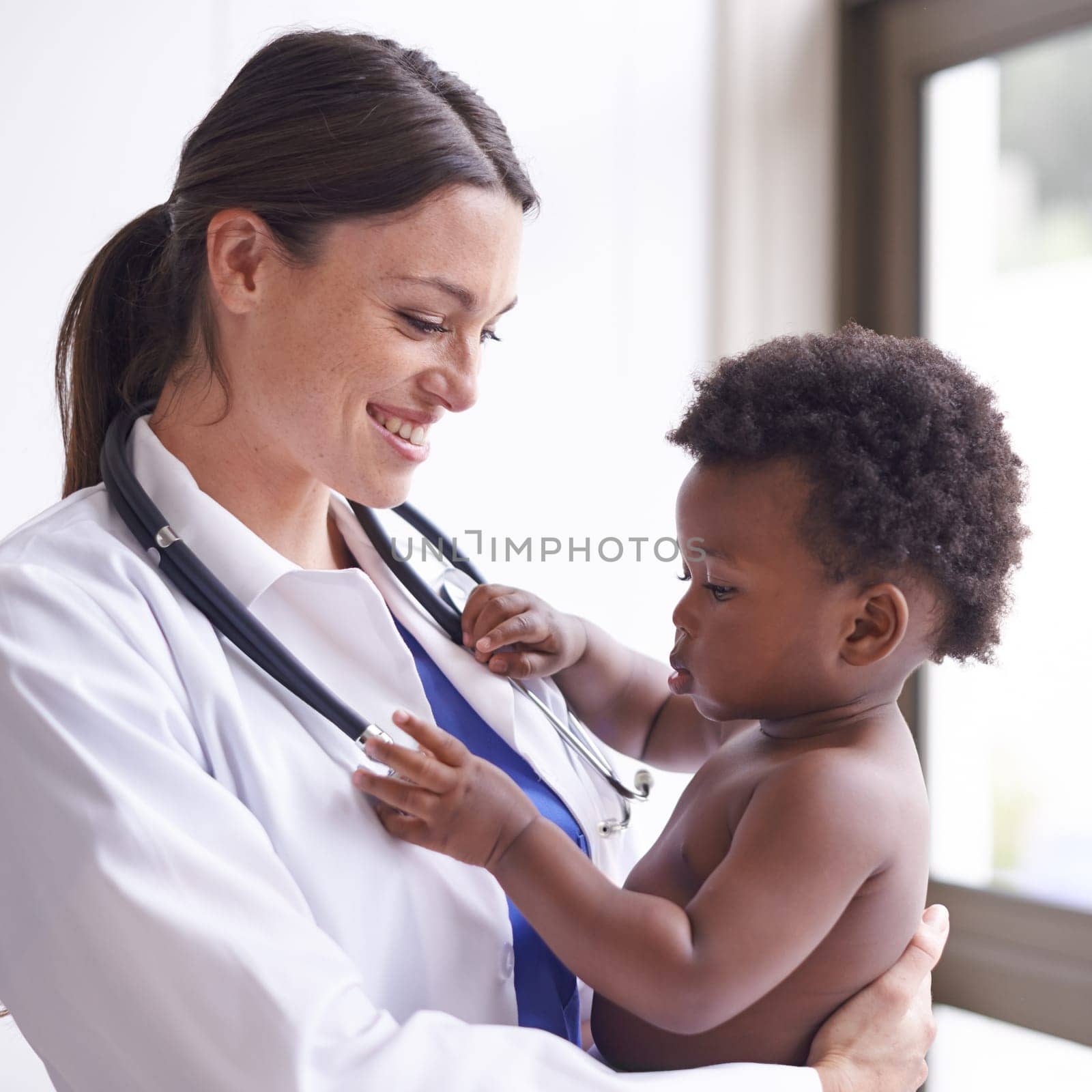 Happy, pediatrician and woman with baby, boy and checkup with stethoscope and doctor in clinic. Medical, professional and employee with healthcare or infant with appointment or medicare with wellness.