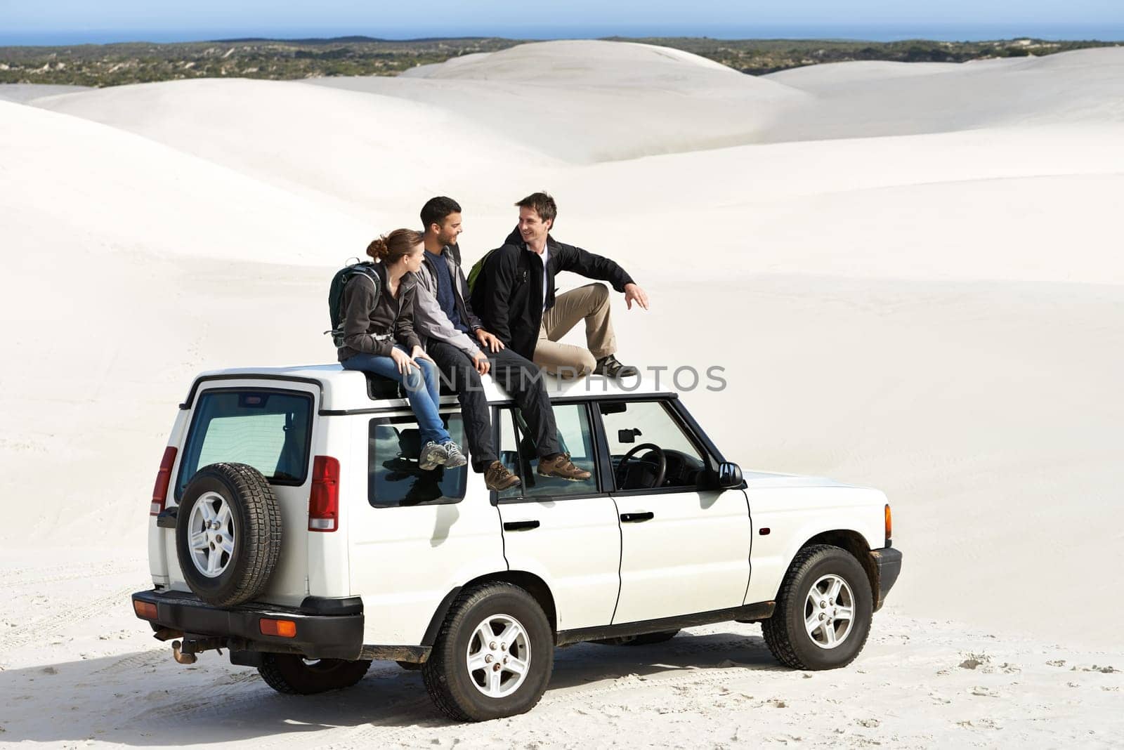 Relax, car and friends sitting on roof for off road drive, summer holiday and communication in sand dune. Car, transportation and people in nature for getaway vacation, travel and journey in Mexico.