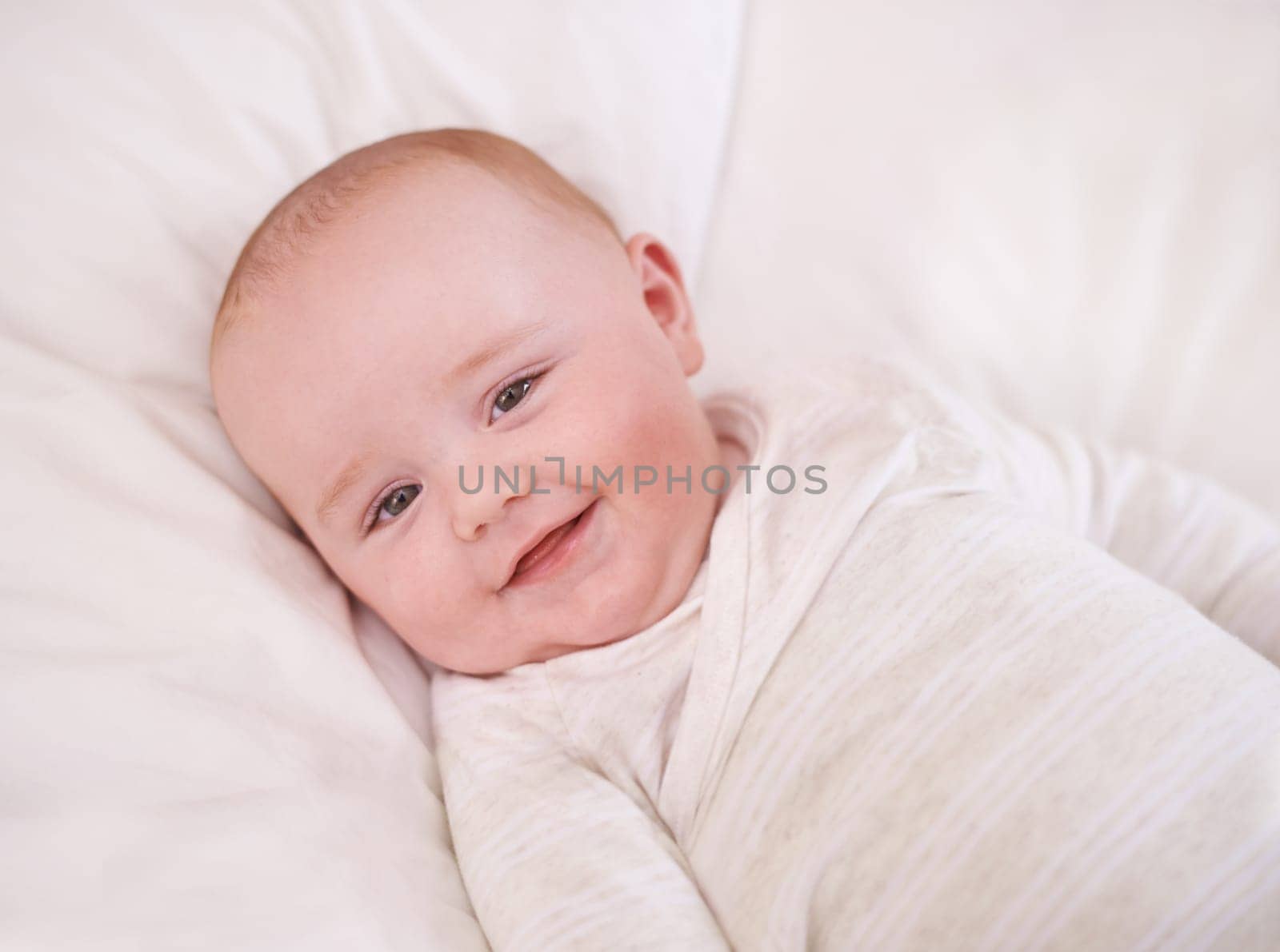 Baby, portrait and smile on bed for relax comfort in family home for childhood development for growth, morning or care. Kid, boy and face on linen bedding in apartment with happiness, love or calm.