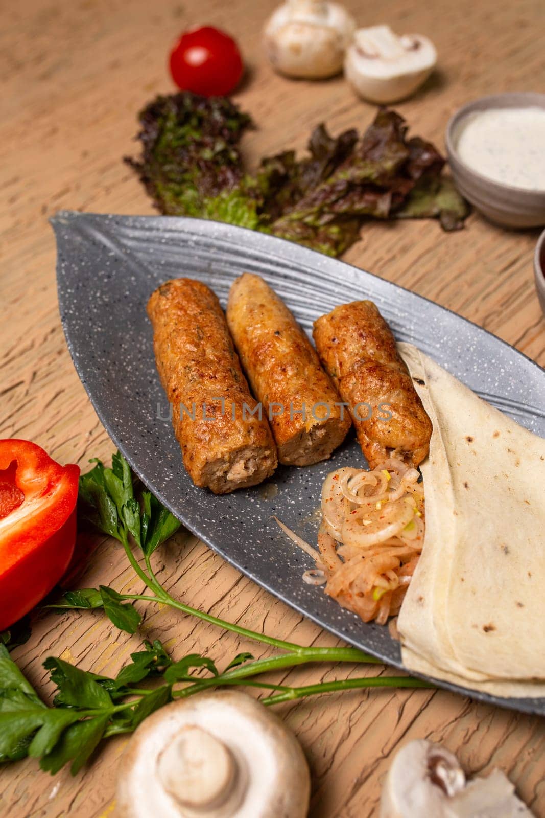 Chicken Kebab Skewers with Grilled Vegetables and Fresh Herbs on Wooden Table by Pukhovskiy