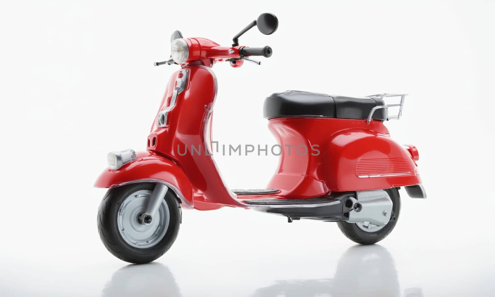 One red plastic scooter on a white background, a toy.