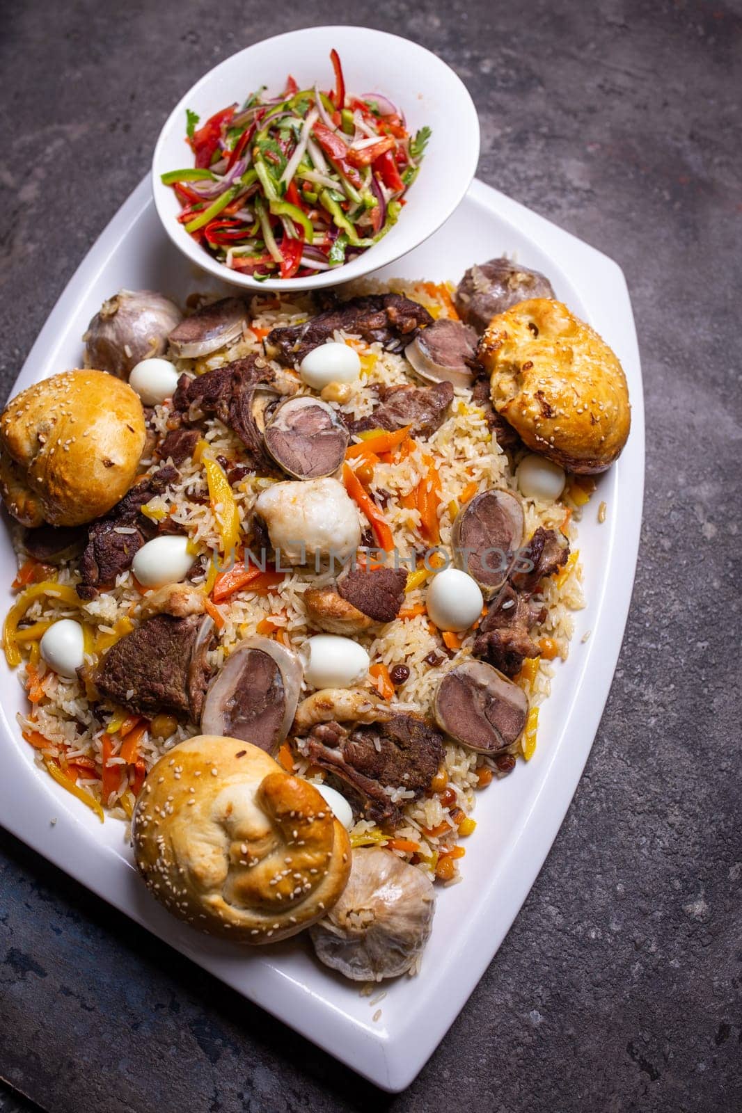 Traditional Uzbek Plov Dish with Mutton, Carrots, and Rice on White Plate. by Pukhovskiy