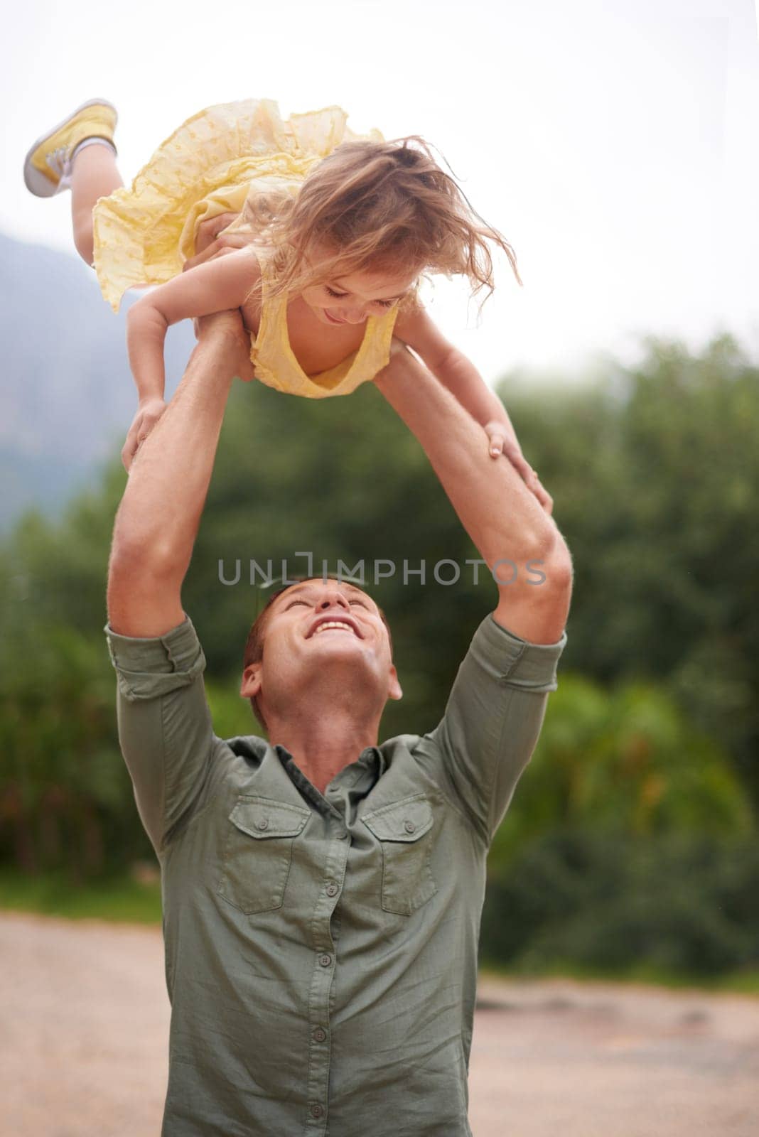 Father, child and lifting outdoor for play together in nature on holiday vacation for love connection, game or adventure. Male person, daughter and happiness in Australia for bonding, fun or travel by YuriArcurs