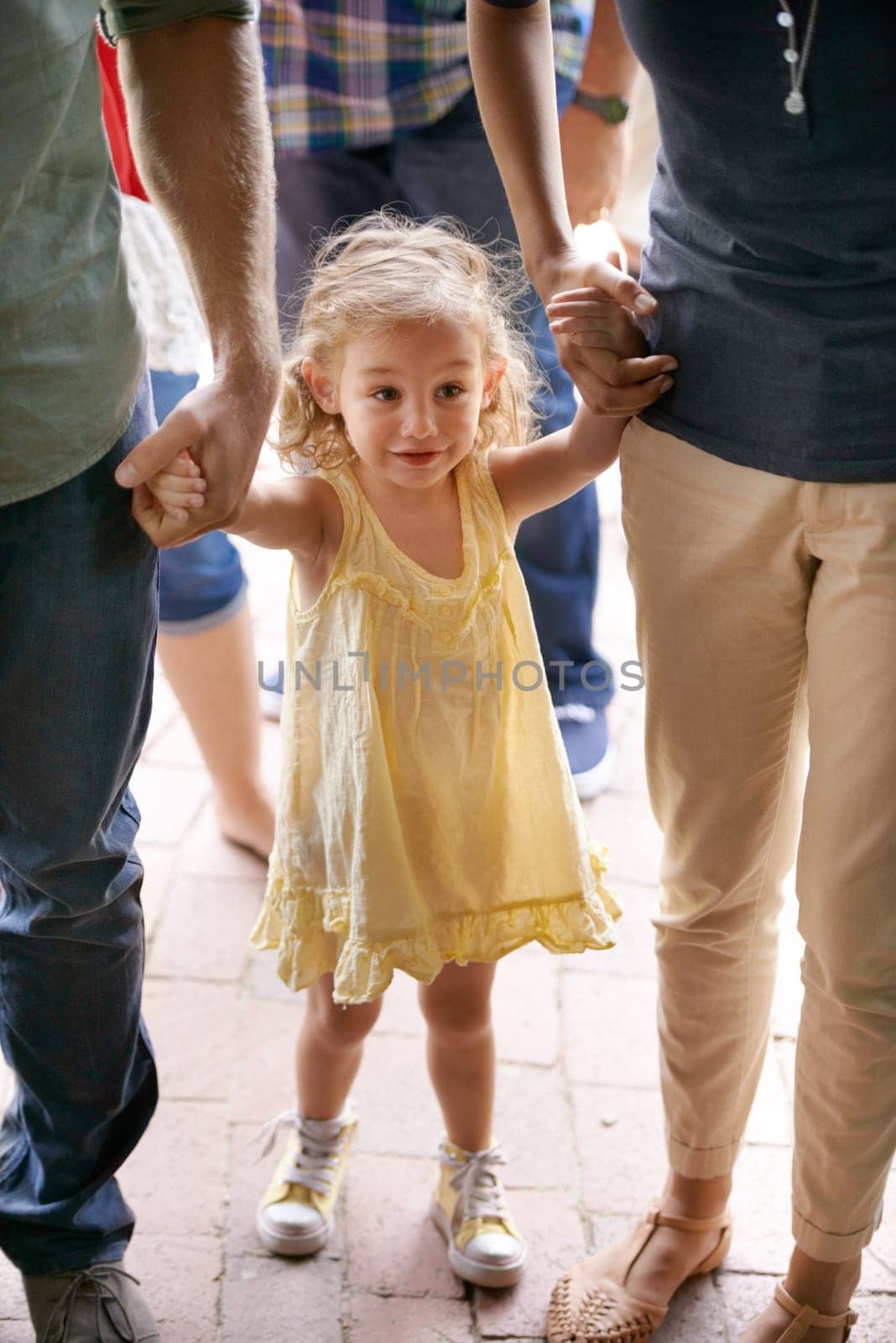 Happy, young girl and family holding hands for travel, fun adventure or holiday weekend in nature. Excited child, mom and dad walking outdoors for sightseeing, bonding and field trip together.