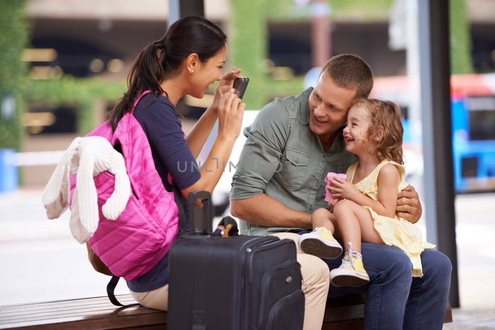 Parents, child and suitcase or photo for vacation memory at airport for travel, bonding or family. Mother, father and daughter for picture with smartphone for America trip, luggage or adventure.
