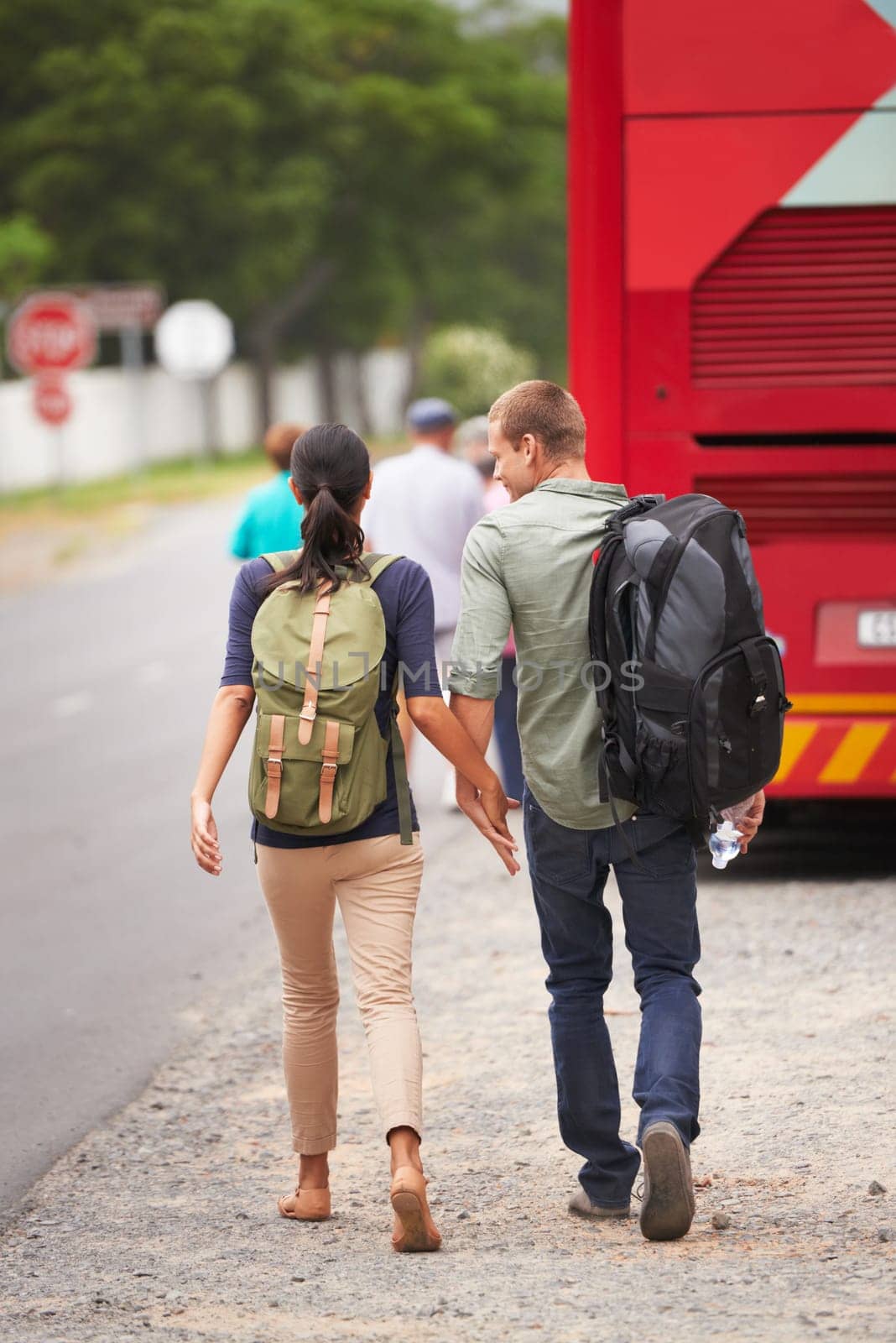 Couple, holding hands and bus for travel on vacation with back, walking and luggage in street with chat. Man, woman and people with connection, love and bonding on holiday for road trip in Costa Rica by YuriArcurs