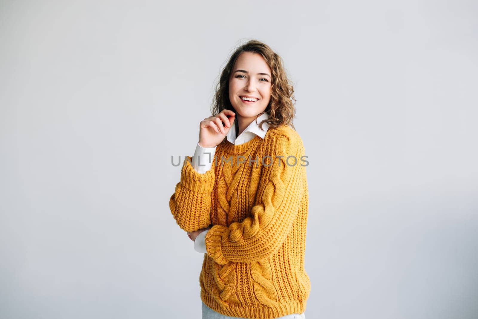 Joyful Young Woman: Smiling, Beautiful, and Charming Model - Positive, Cheerful, and Pretty - Curly-haired Student Laughs, Looks at Camera - Isolated Portrait on White Background - Expressive and Satisfied Expression by ViShark