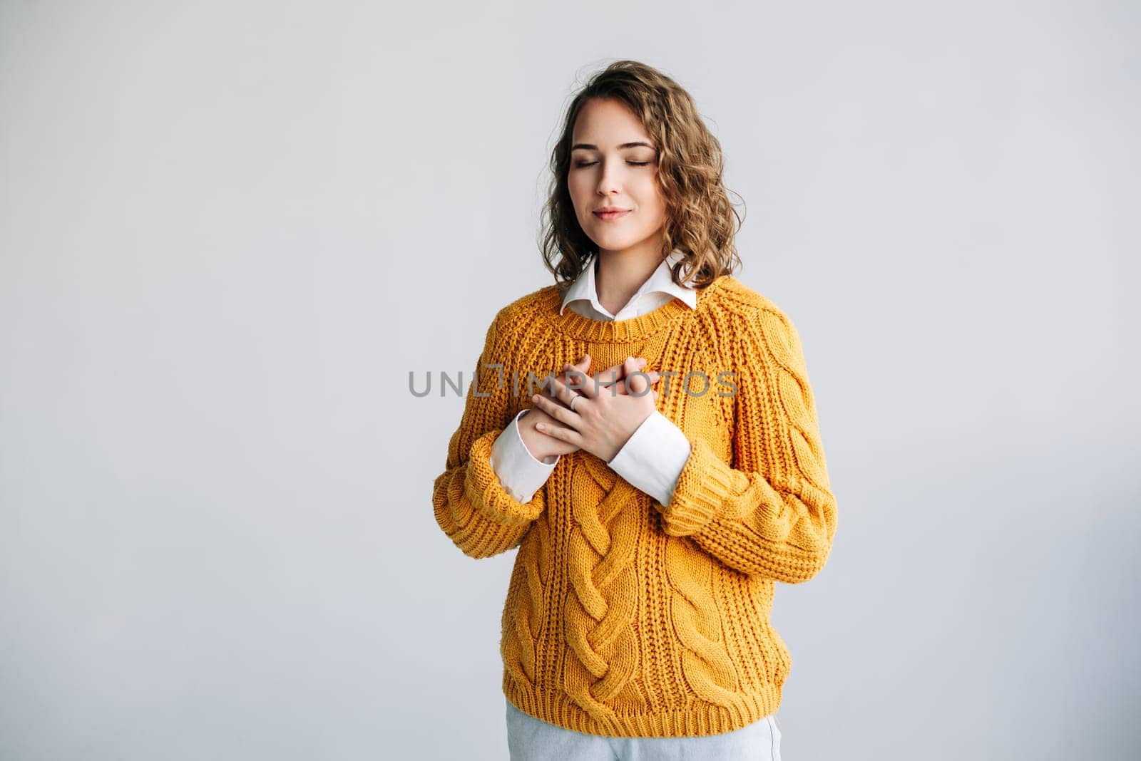 Grateful Woman: Hands on Chest, Expressing Happiness, Mental Balance - Thankfulness, Kindness, Love - Isolated Portrait on White Background - Conceptual Image of Gratitude and Emotional Well-being by ViShark