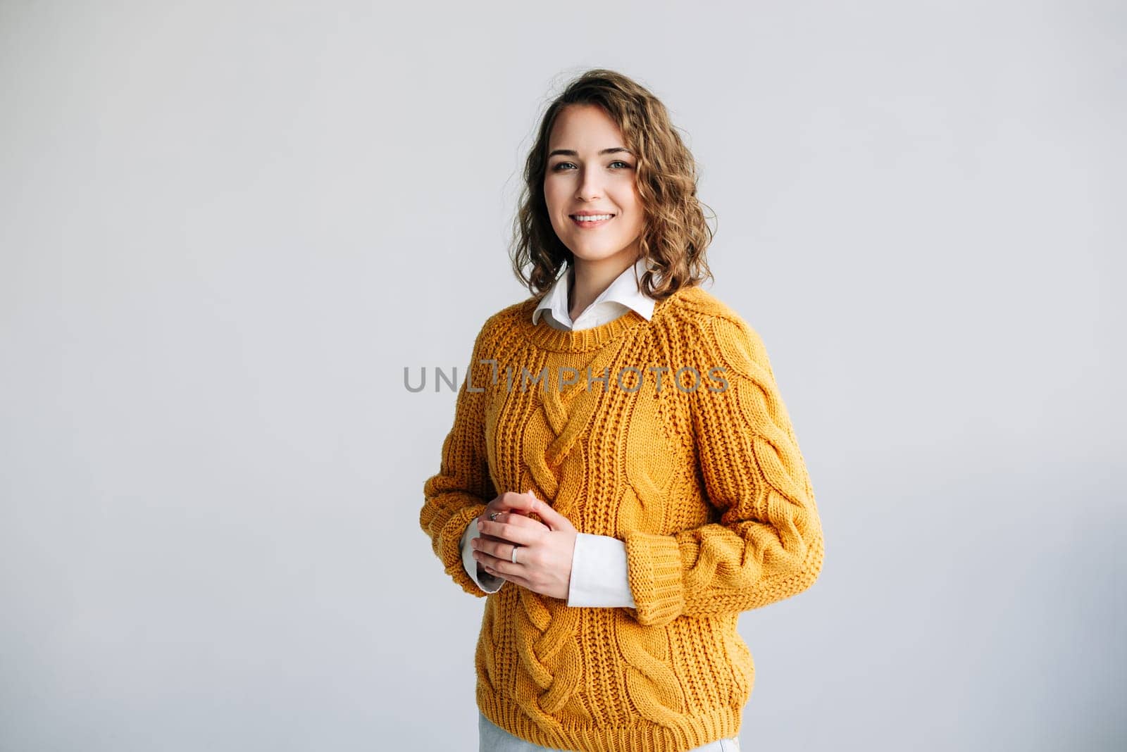 Joyful Professional Woman: Smiling, Beautiful, and Charming Model - Positive, Cheerful, and Pretty - Curly-haired Student Looks at Camera - Isolated Portrait - Confident and Vibrant Expression.