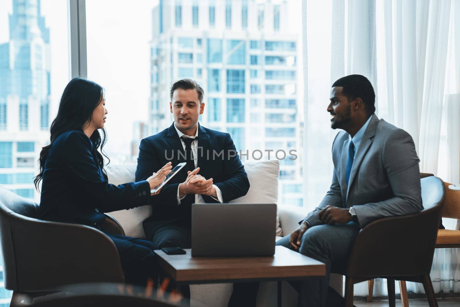 Young smart businesswoman showing data analysis to diverse investor by using tablet. Multicultural business group discussing and investing in start up project. Modern office. Meeting. Ornamented.