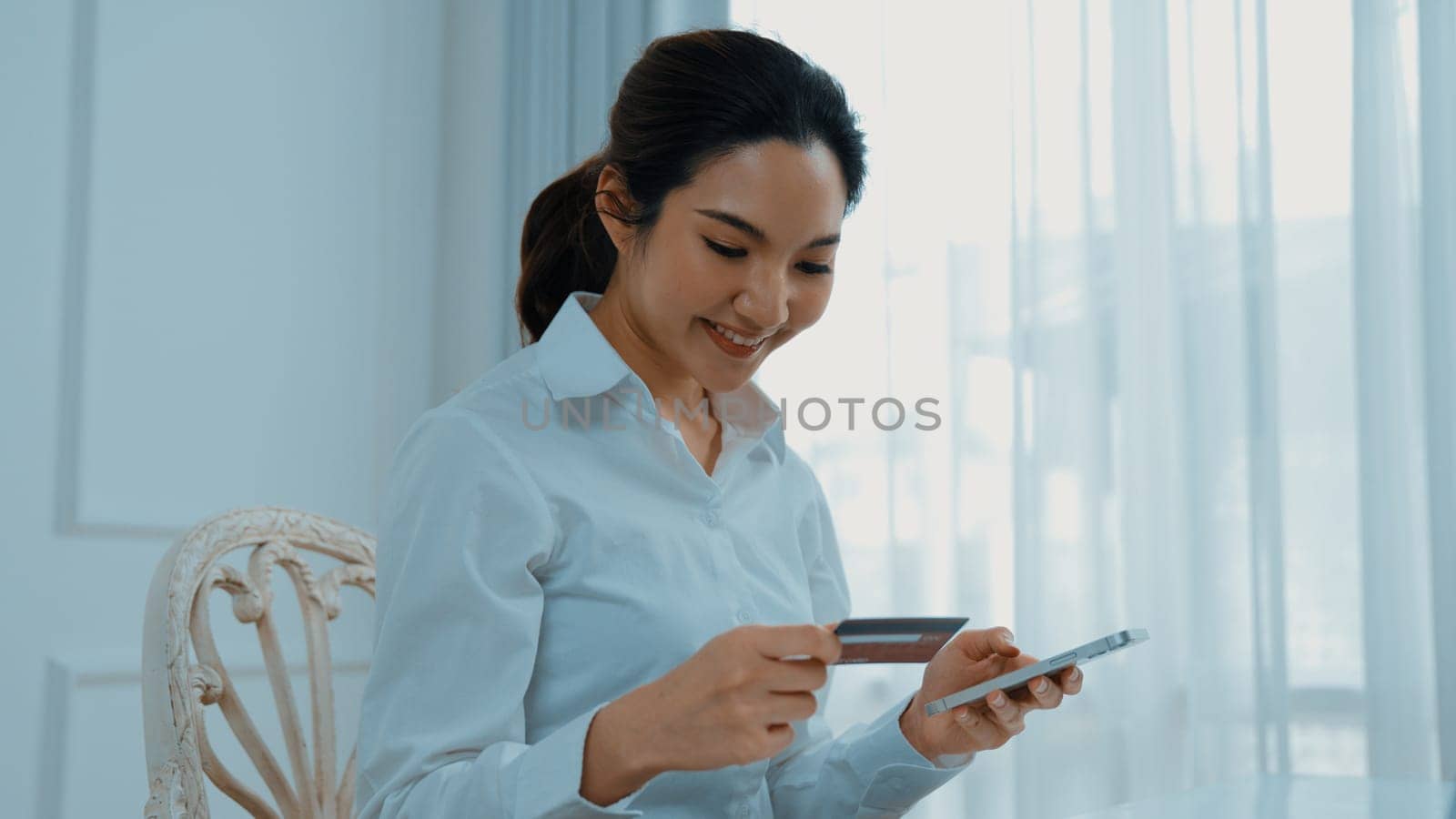 Woman shopping or pay online on internet marketplace browsing for sale items for modern lifestyle and use credit card for online payment from wallet protected by vivancy cyber security software