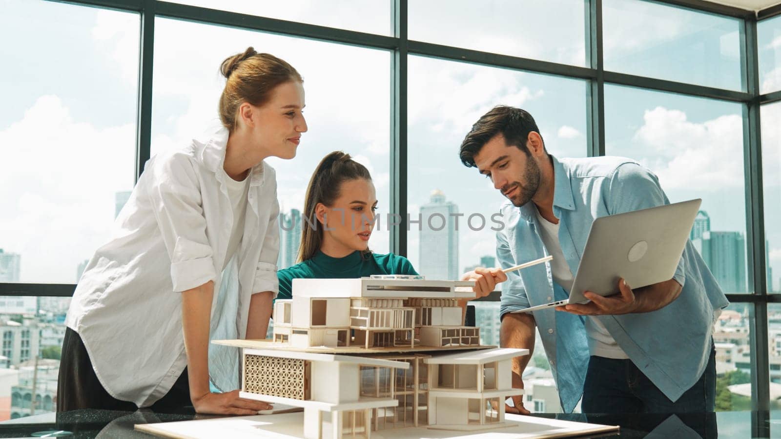 Smart architect team discussion about house design while handsome male worker present idea by using laptop. Group of professional engineer sharing, brainstorming design. Business design. Tracery