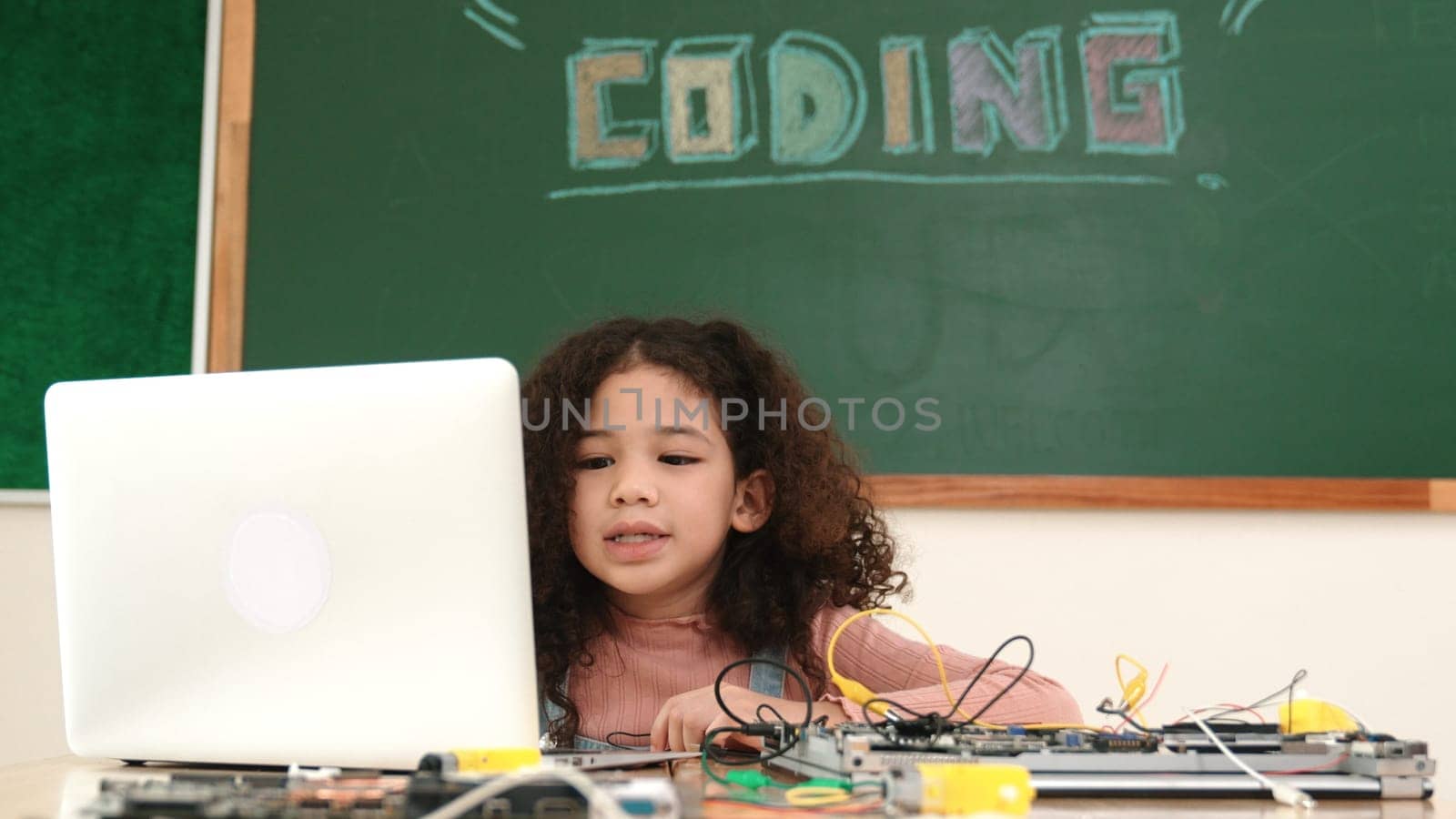 Attractive african student programing system while looking at screen. American girl working on her laptop while coding engineering prompt and generating AI by using software at Stem lesson. Pedagogy.