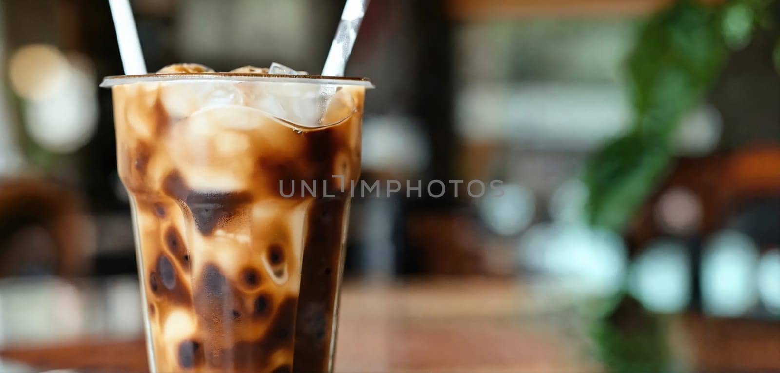 Milk Being Poured Into Iced Coffee on a dark table. Generative AI