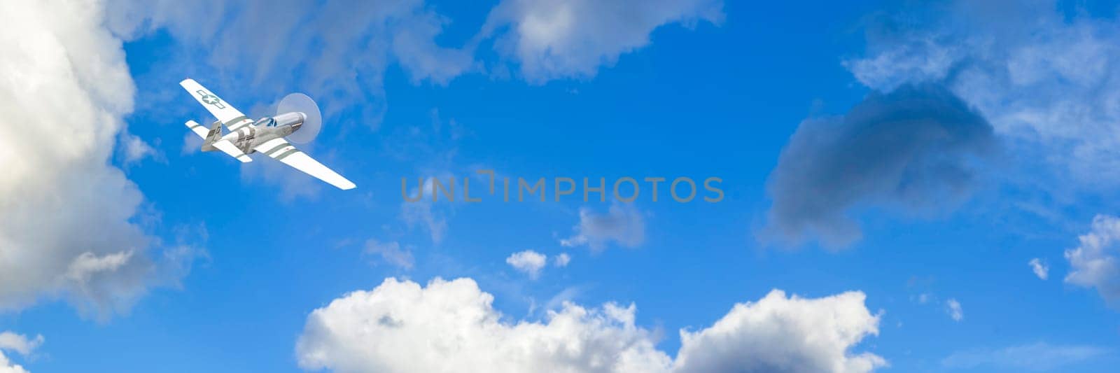A solitary propeller airplane captured mid-flight with its distinct markings, cruising through a bright sky peppered with clouds.