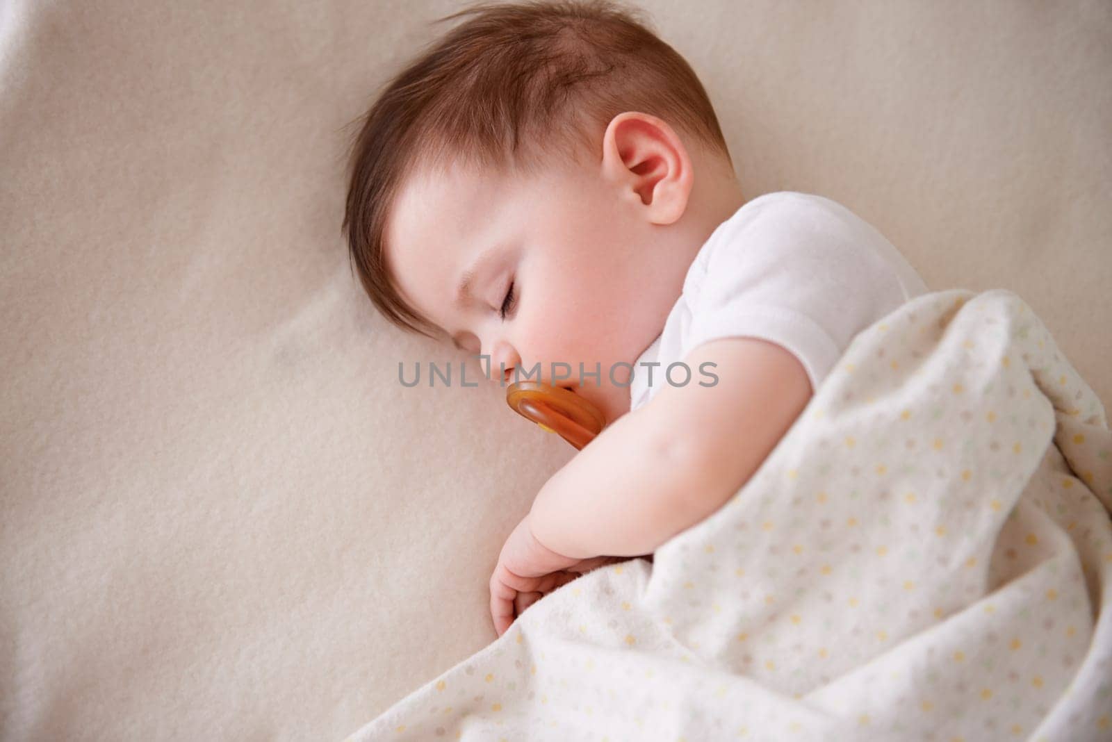 Baby, sleeping and home with tired, sleepy and nursery with peace in a bed with blanket. Morning, youth and kid with dream of an infant with child development from rest in a bedroom with a newborn.