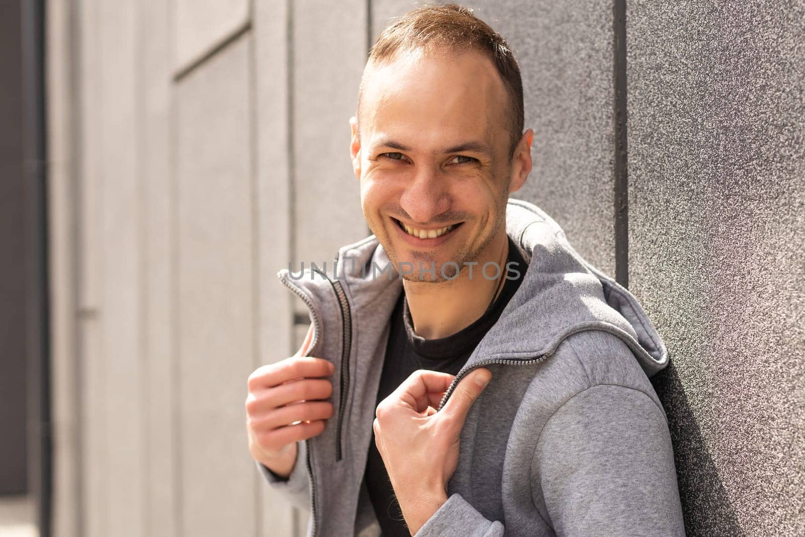 Successful caucasian middle-aged man in casual outfit with arms crossed isolated over gray background.